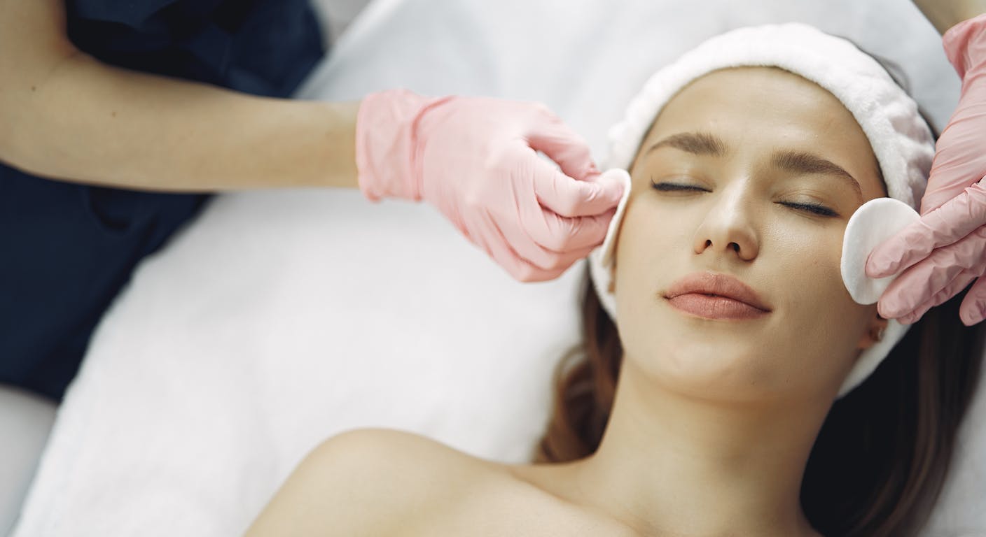 Profesional realizando tratamiento de depilación eléctrica facial en centro de estética